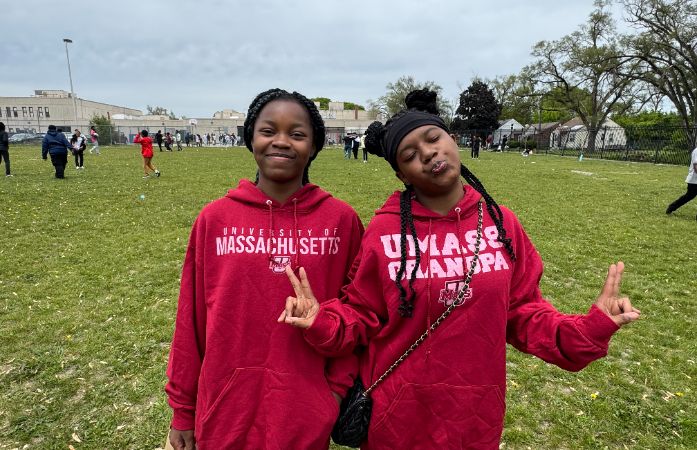  2 girls with sweatsuits on smiling
