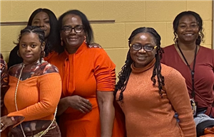  women with orange clothing on