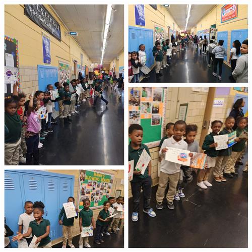 Young students holding signs participate in pep rally