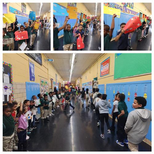 Young students holding signs participate in pep rally