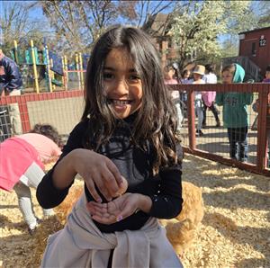 a girl holding a chicken egg