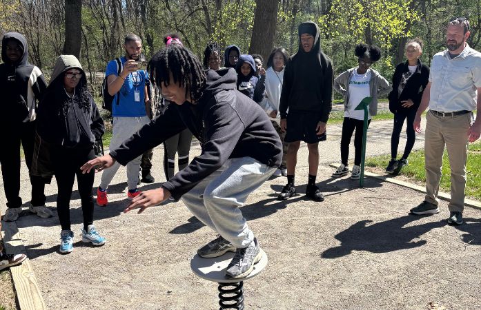  student balancing on exercise equipment 