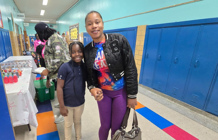  mother and daughter smiling in hallway