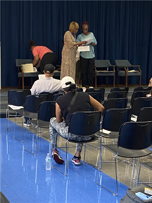 Prinicpal and parent on stage during parent meeting