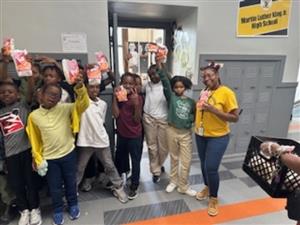  teacher standing with students holding popcorn