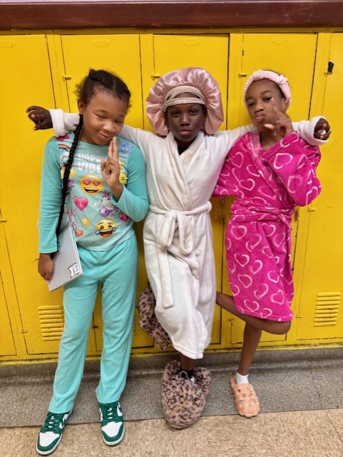  kids dressed in pajamas standing