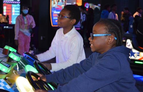  2 male students playing a video game
