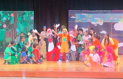  Cast of Seussical performing on stage