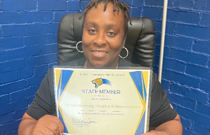  Teacher holding award