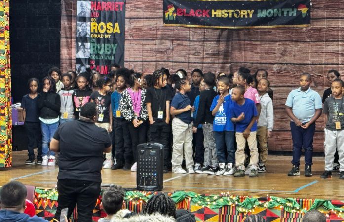  Kids standing on stage singing