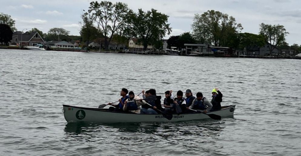  Western Student paddling a canoe on the Shores of Lake Erie