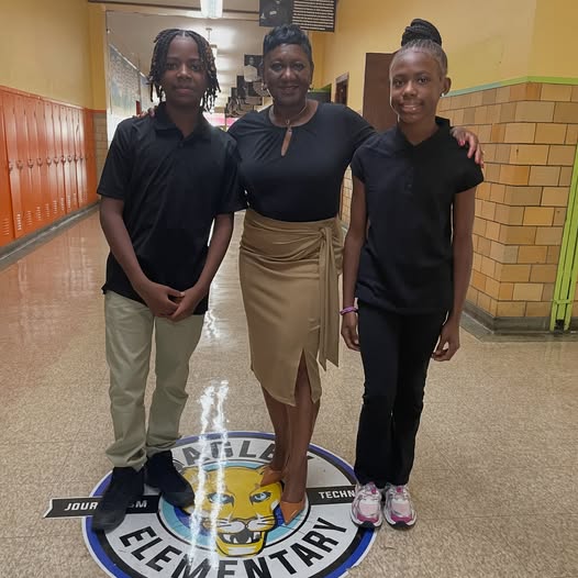 Prinicipal taking a picture with 7th graders