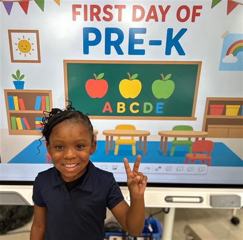 prek student posing in front of poster