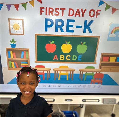 prek student posing in front of poster
