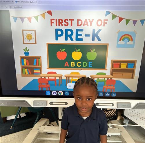prek student posing in front of poster