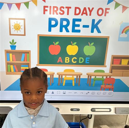 prek student posing in front of poster
