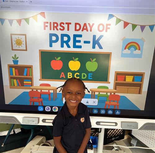 prek student posing in front of poster