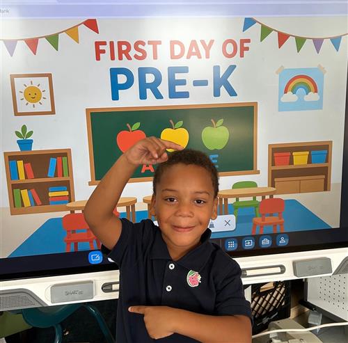 prek student posing in front of poster