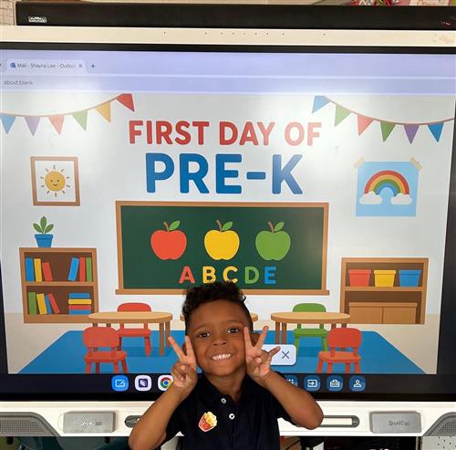 prek student posing in front of poster