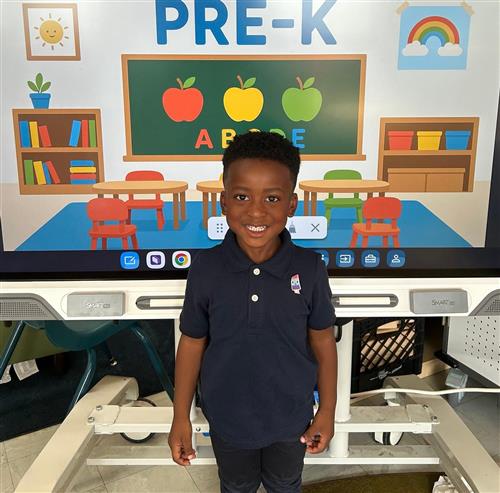 prek student posing in front of poster