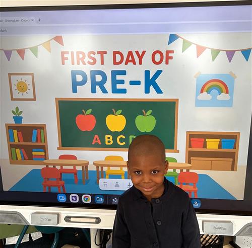 prek student posing in front of poster
