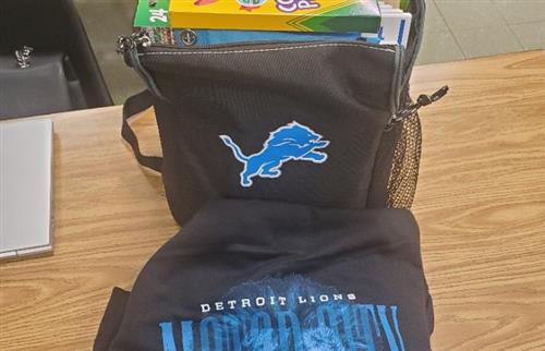 bookbag filled with school supplies and Lions hoodie