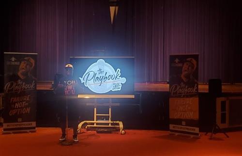 Man standing in front of a microphone talking