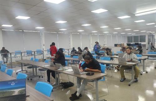  students in a room on computers completing FAFSA forms