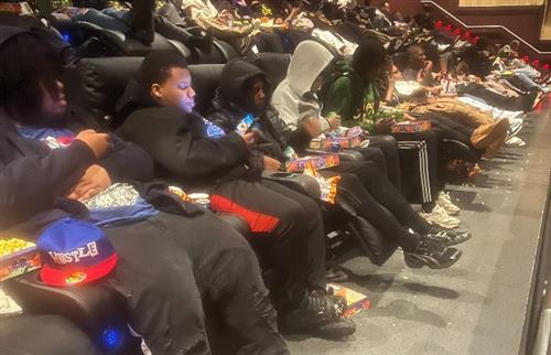students sitting in movie theatre 