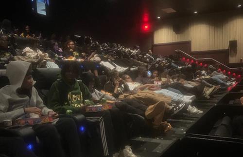 students sitting in movie theatre 