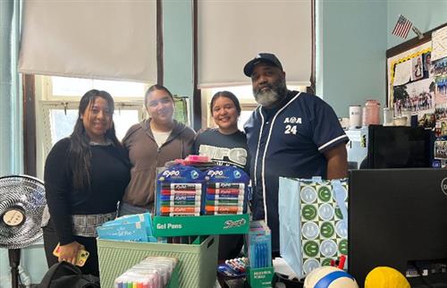  Former students with thier donated supplies.