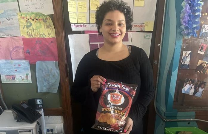   313 day with Ms. Walker's 2nd grade class, teacher holding Detroit "Better Made" chips