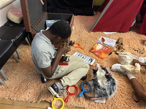  student looking through a microscope and examining item relating to autumn 