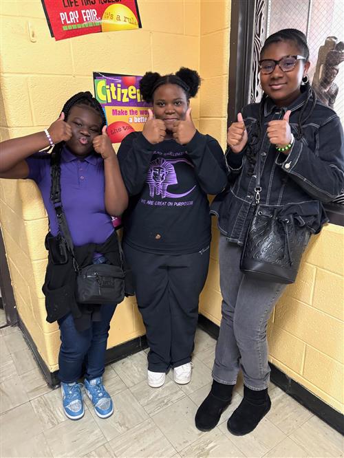  three smiling girls giving the thumbs-up