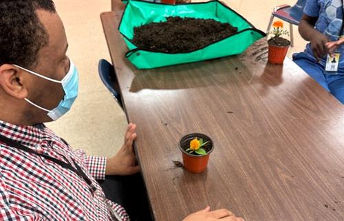  student sitting with flower