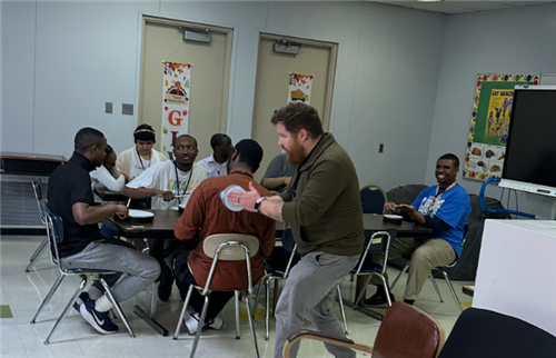  students drumming with instructor