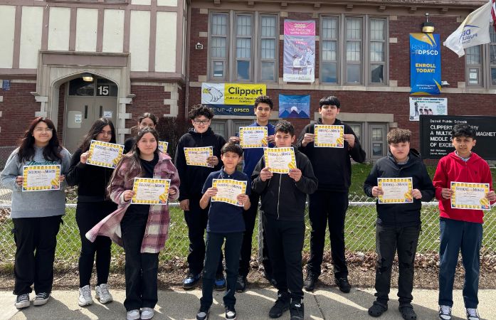 students standing with their certificates