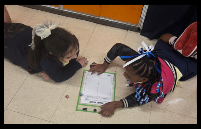  2 students working on math problem together 