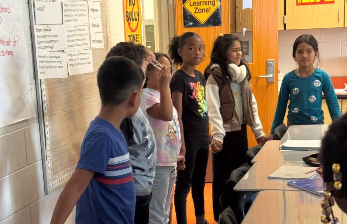  students holding hands smiling