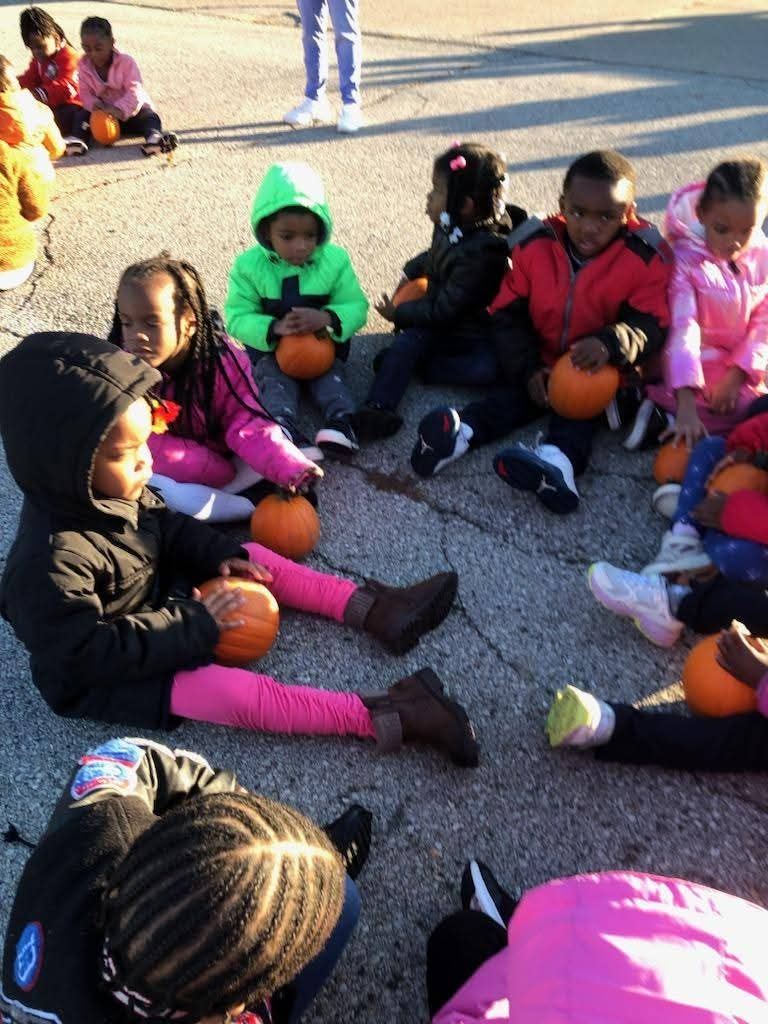  kids holding pumpkins