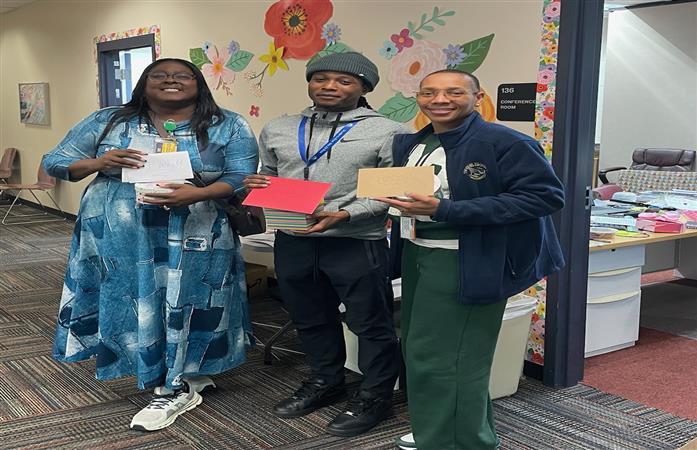 3 Administrators holding cards