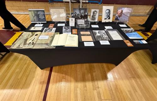 A black table with black history artifacts displayed