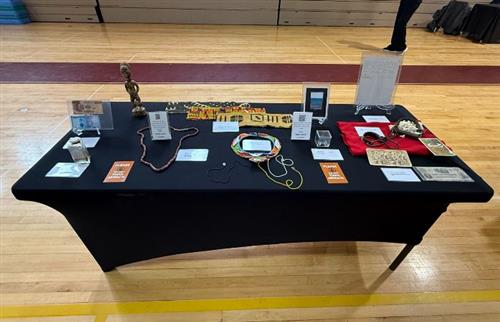 A black table with black history artifacts displayed