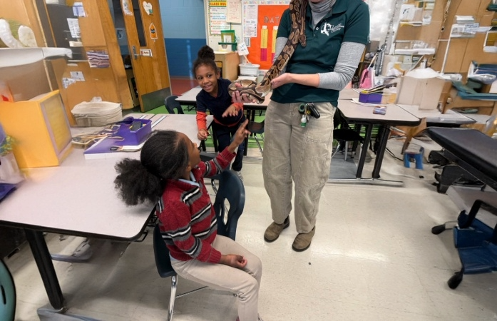  Students looking at snake in handlers hand