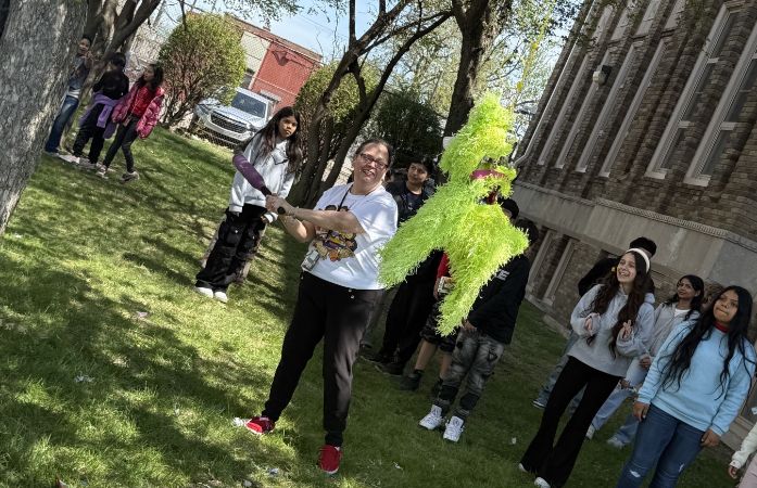  Principal swinging at the pinata