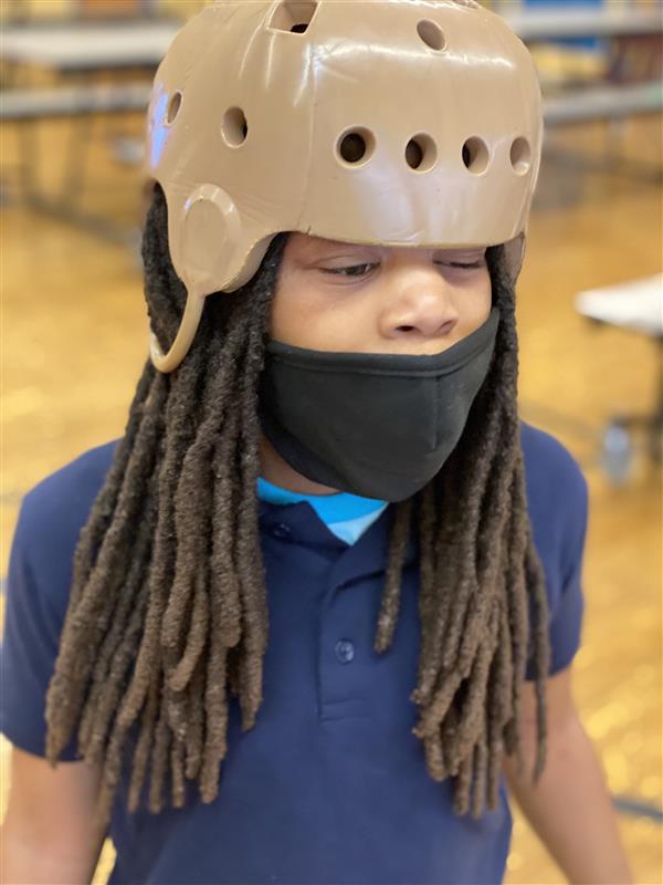 masked student wearing a helmet